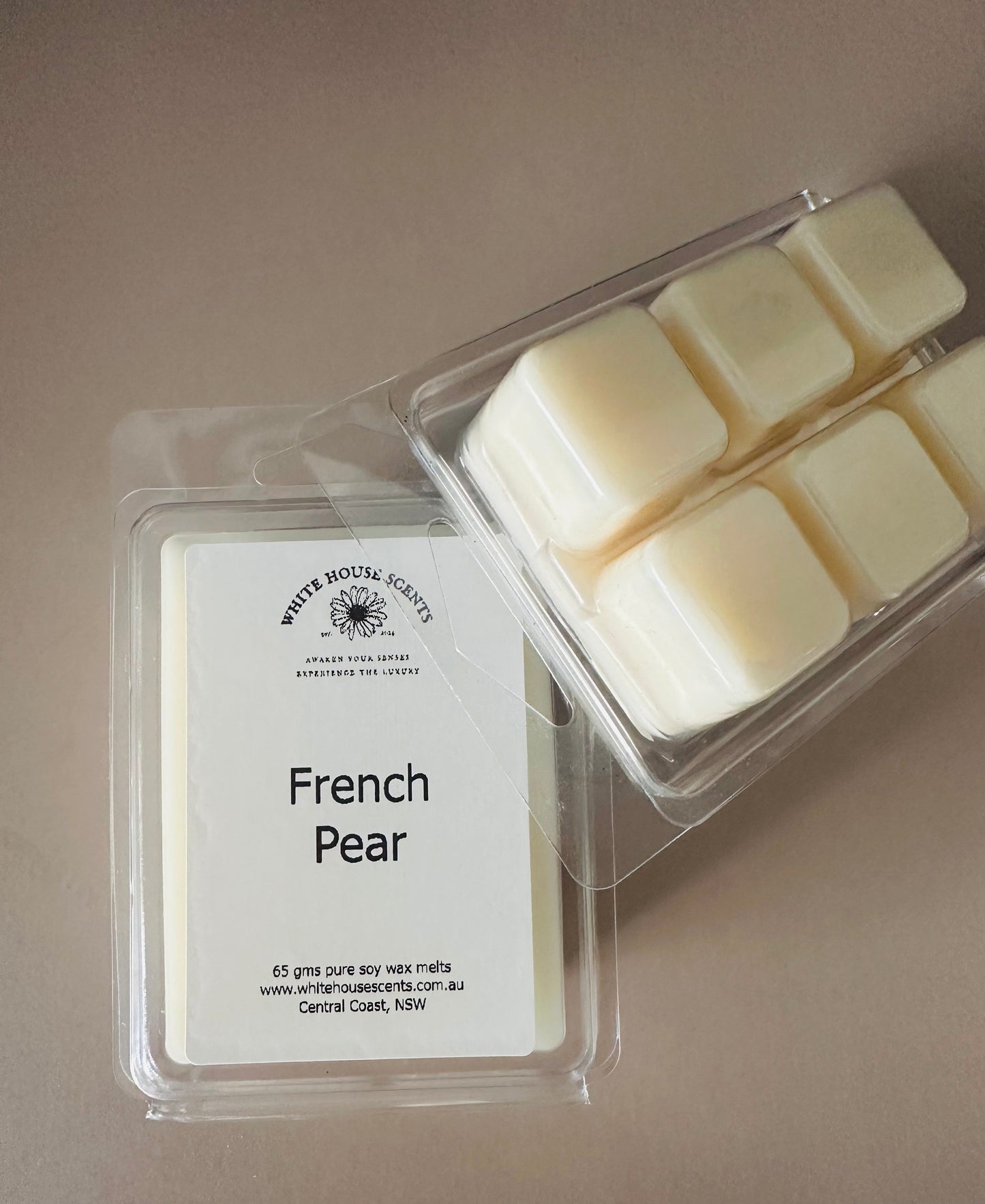 Packaged wax melts labeled 'French Pear' on a neutral background