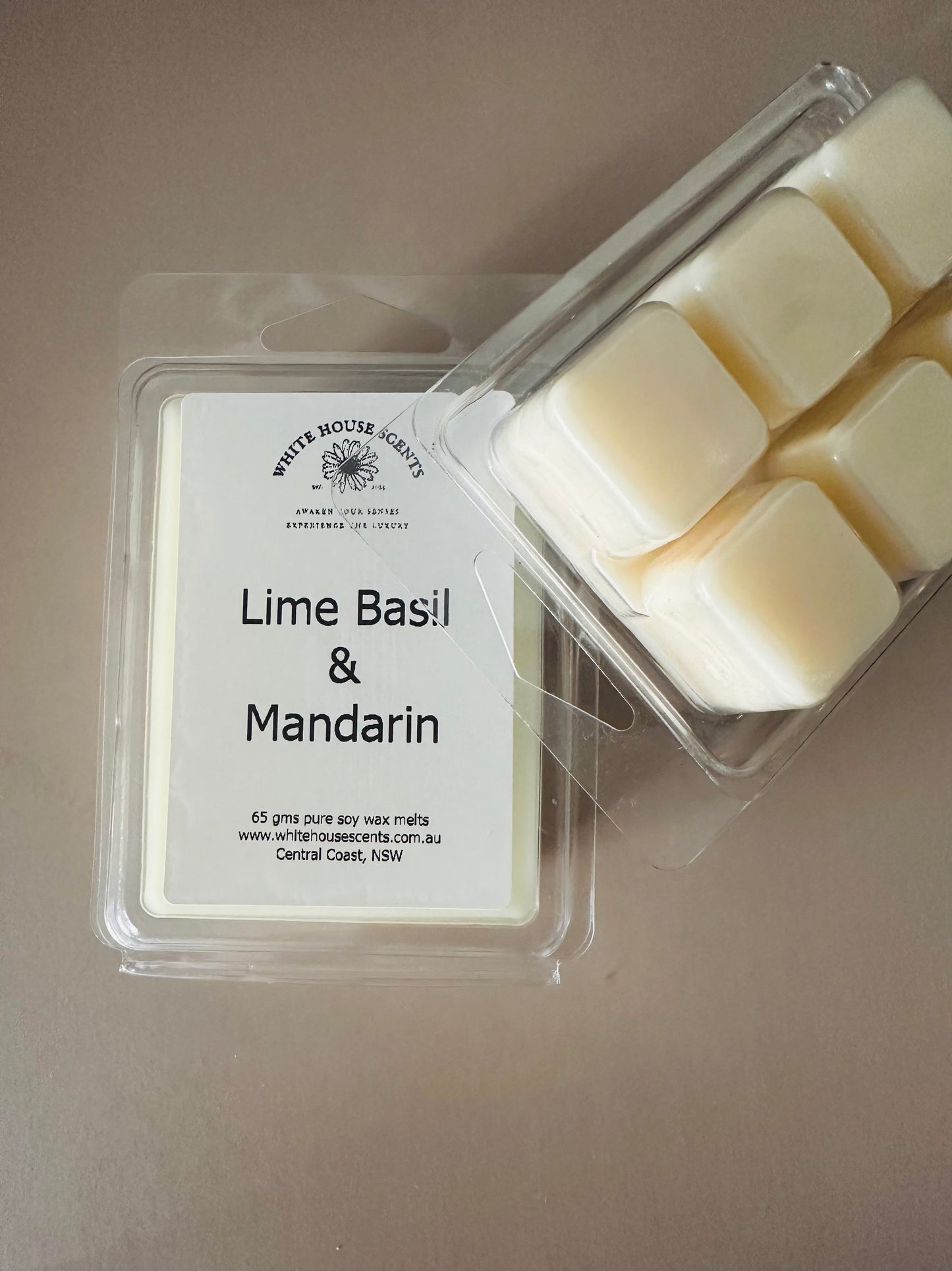 Packaged lime basil and mandarin wax melts on a neutral background