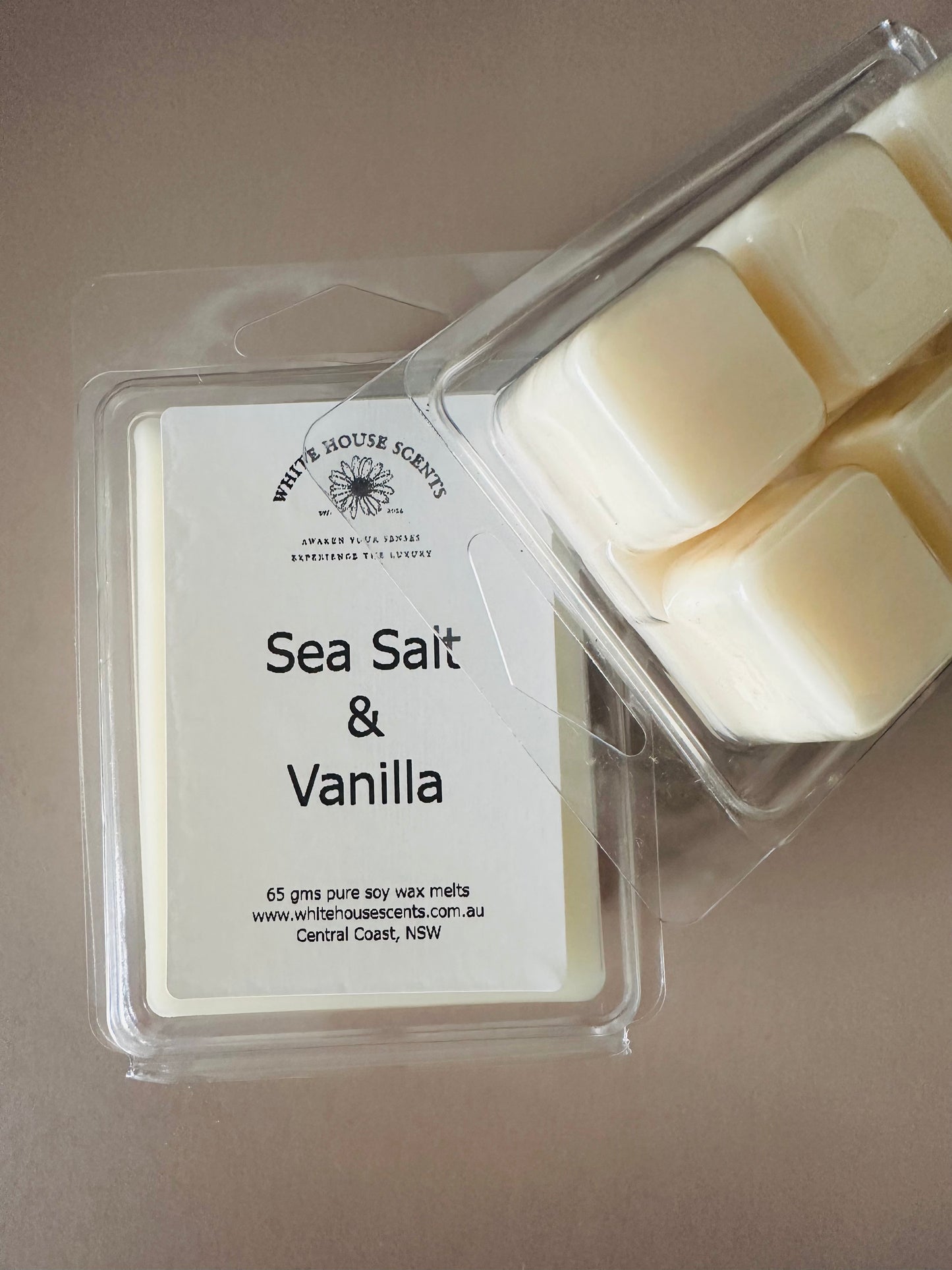 White House Scents Sea Salt & Vanilla wax melts in a clear container on a beige background