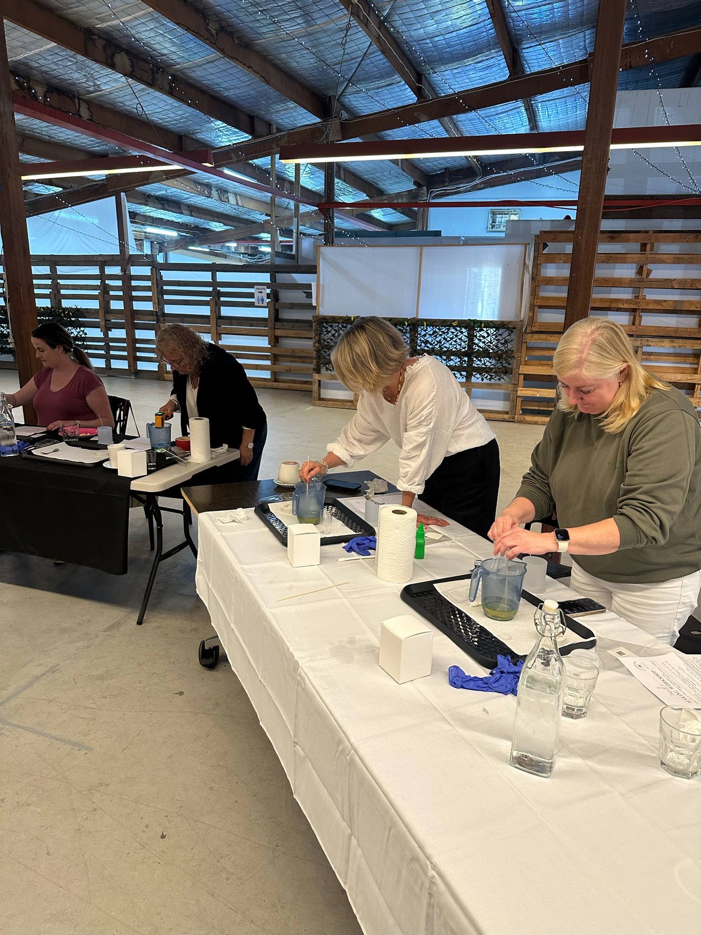 People working at a table in a workshop or classroom setting.
