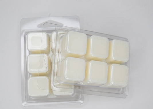 Pack of wax melts in a clear plastic container on a light gray background